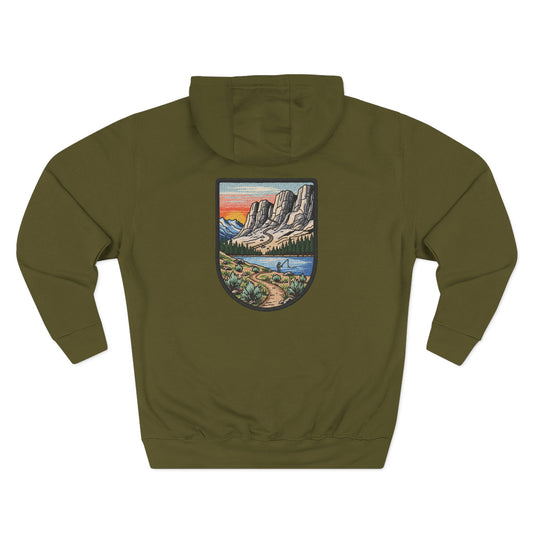 Green hoodie with a mountain landscape patch on the back against a white background