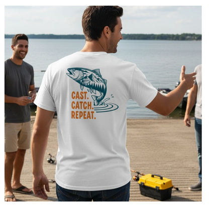 Man wearing a white t-shirt with a fish graphic and text by a lakeside.