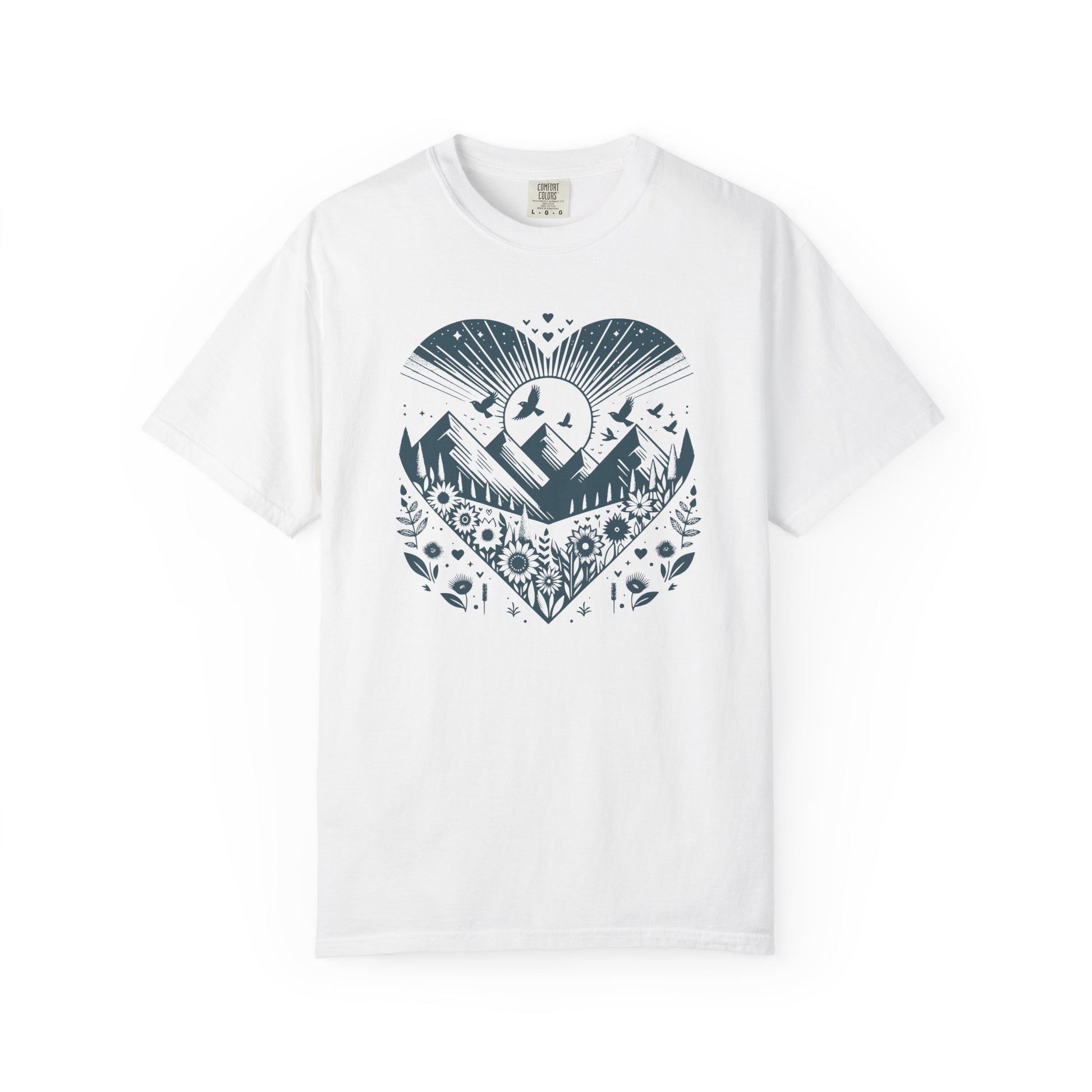 White t-shirt with navy heart-shaped nature graphic showing mountains, sun, birds, and wildflowers